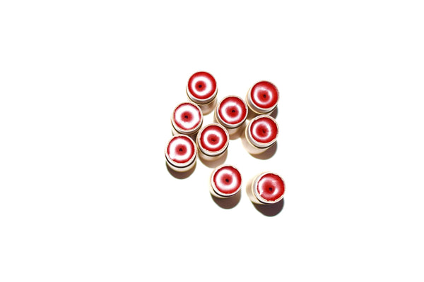 Red and white circular objects on a white background