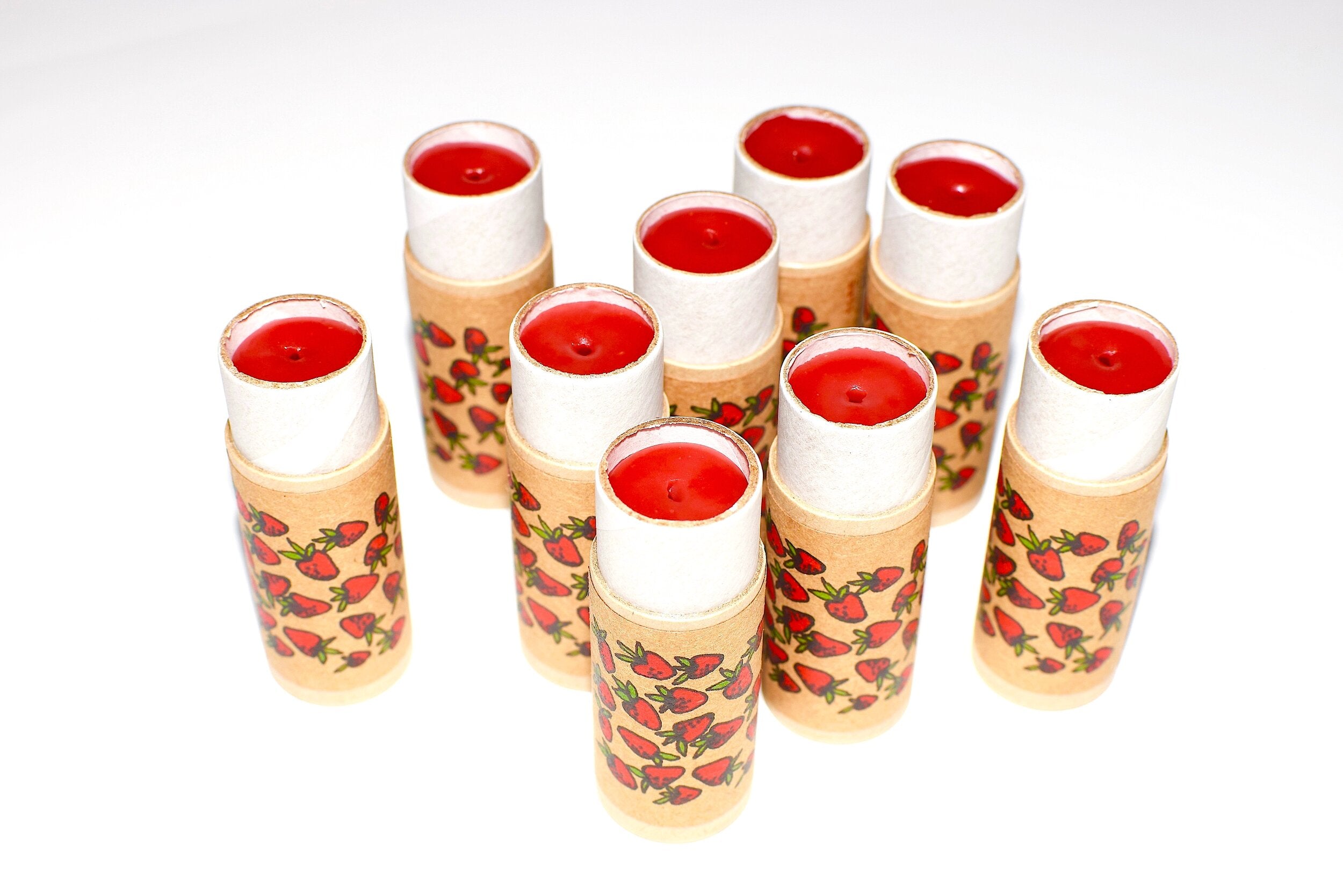 Set of candles with strawberry design on a white background