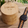 Wooden watch and engraved wooden box on a wooden surface with 'Vikingens' branding.