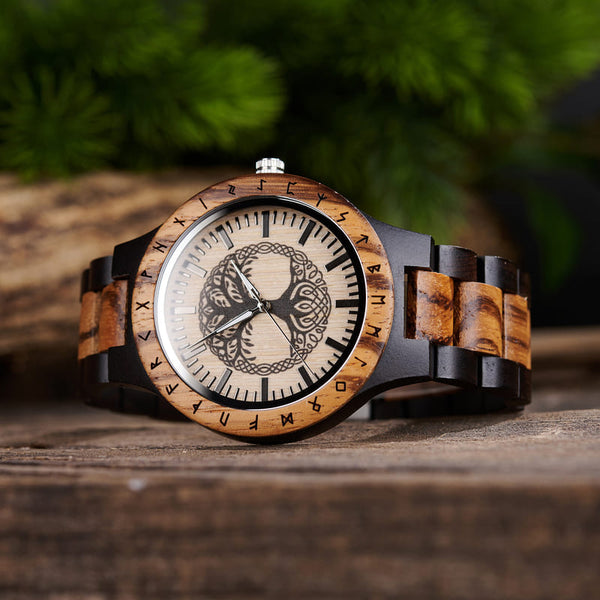 Close-up of Tree of Life engraving detail on handmade wooden watch face with luminous dials