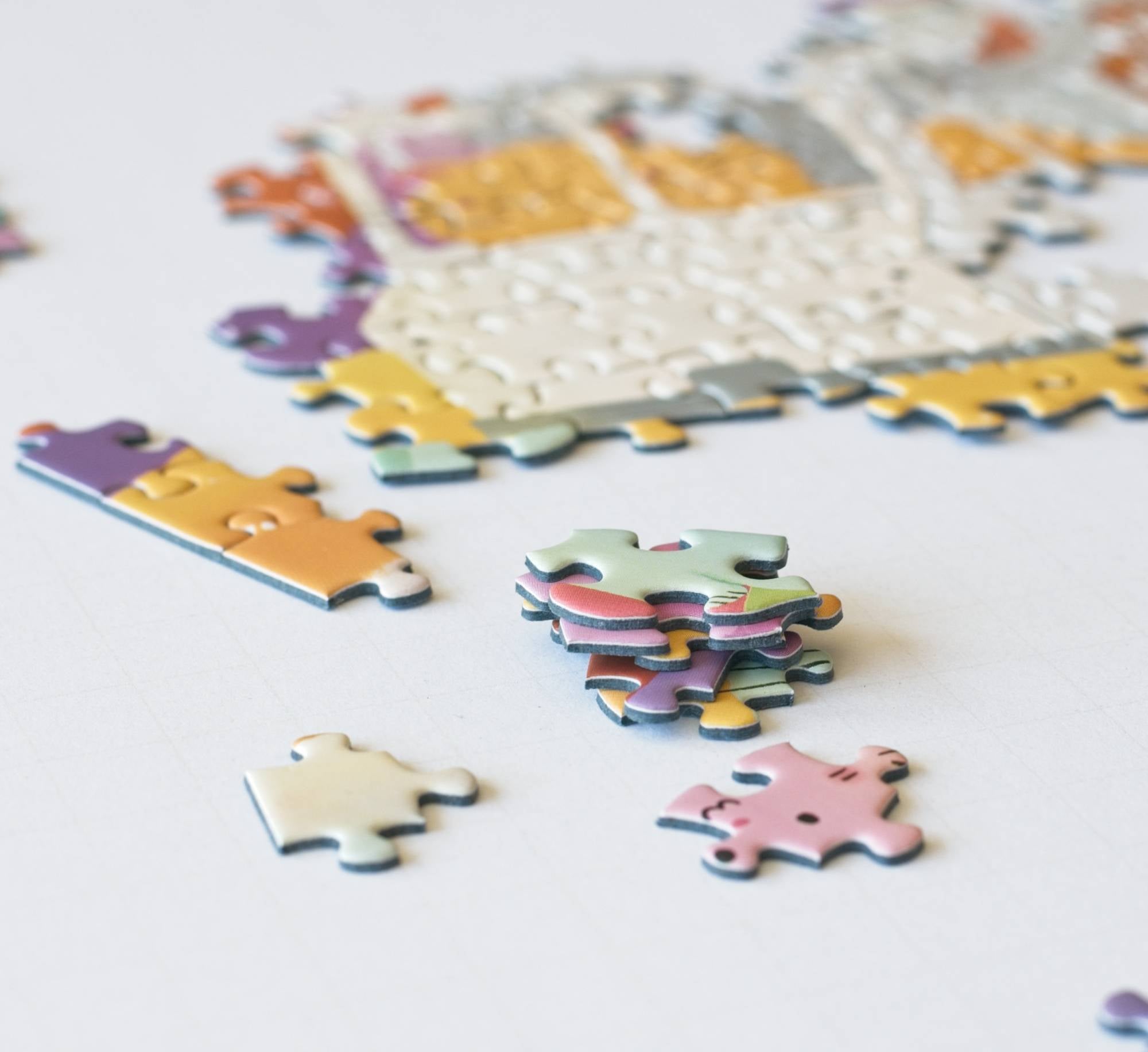 Colorful puzzle pieces on a white surface