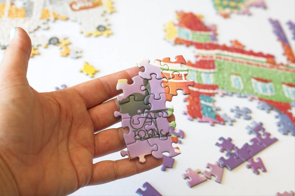 Cat Town Whimsy jigsaw puzzle box and reusable resealable piece bag showing eco-friendly recycled materials packaging