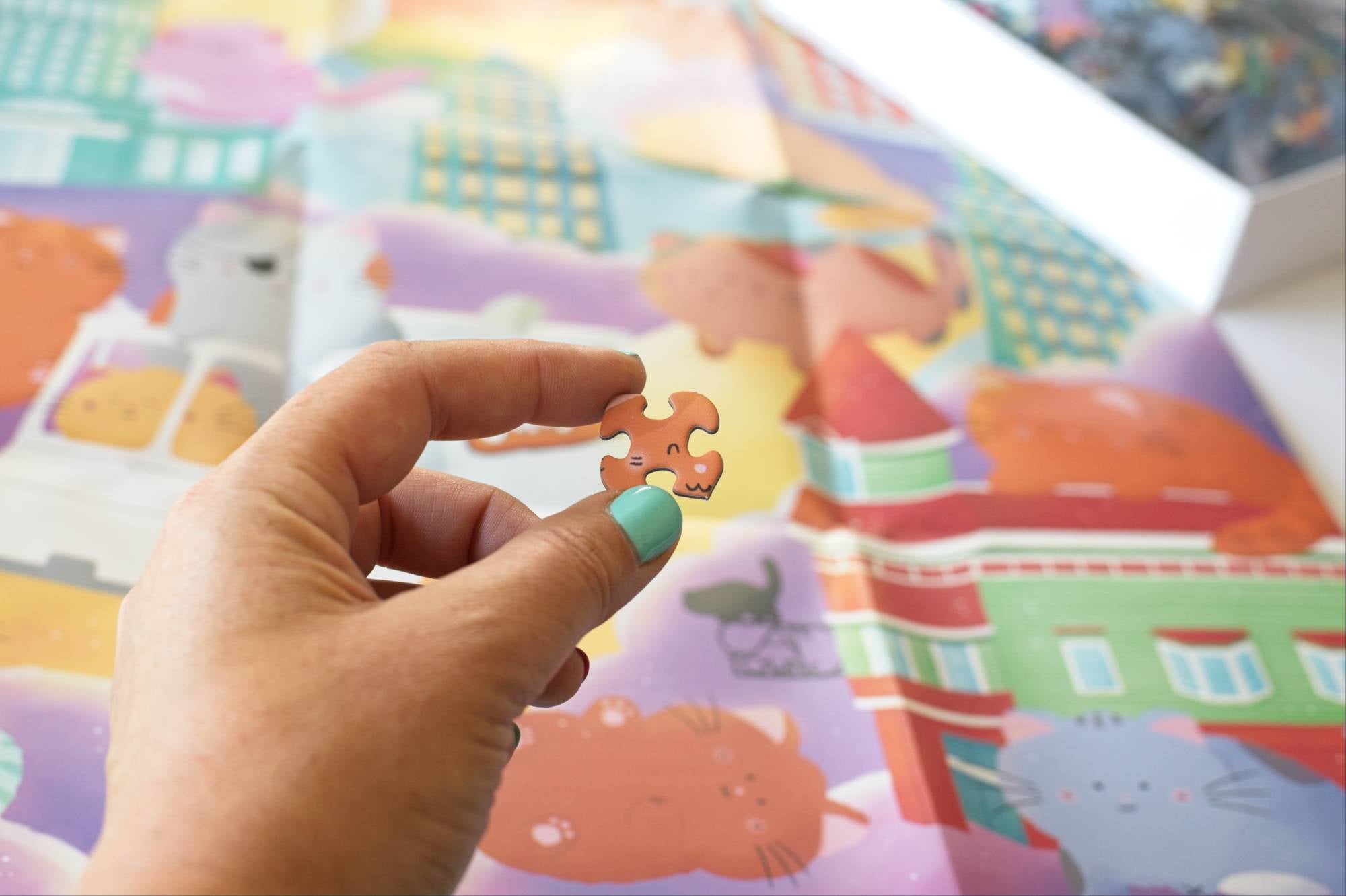 Hand holding a puzzle piece in front of a colorful children's book