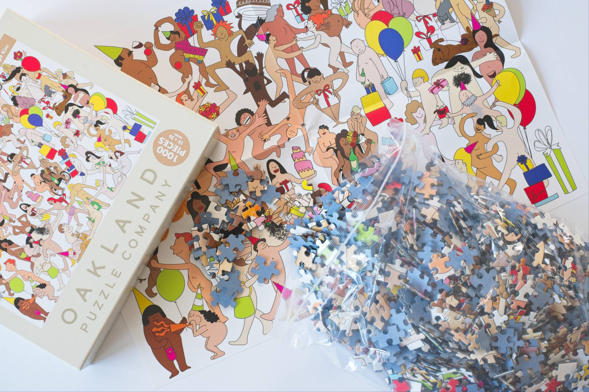 Close-up of Birthday Suits puzzle pieces showing ribbon-cut design, matte finish, and low-dust surface