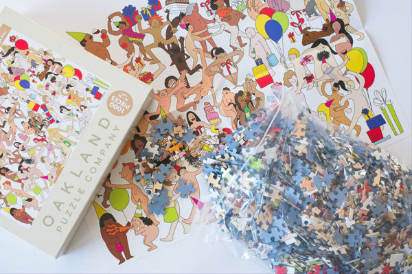 Close-up of Birthday Suits puzzle pieces showing ribbon-cut design, matte finish, and low-dust surface
