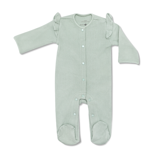 Green baby onesie with ruffled shoulder straps on a white background