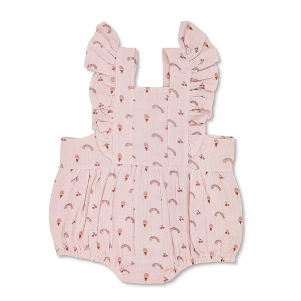 Baby wearing organic muslin flutter sleeve romper in rainbows and ice cream print by Apple Park