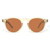 Sunglasses with gold frame and brown lenses on a white background