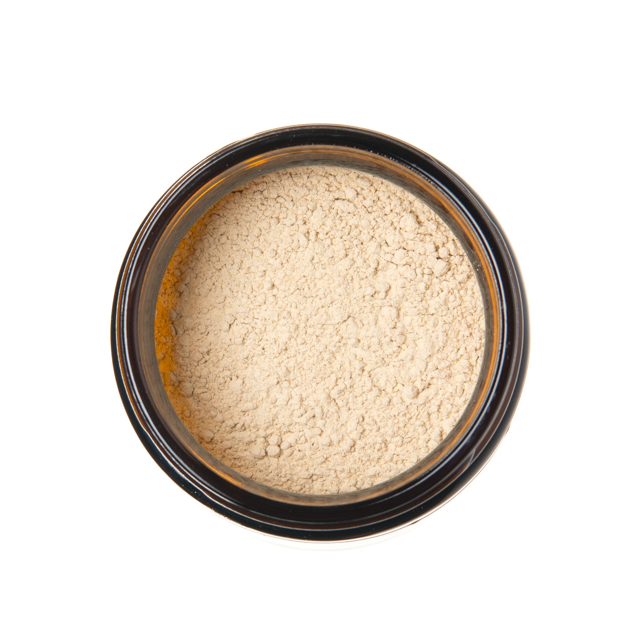 Beige powder in a black container on a white background