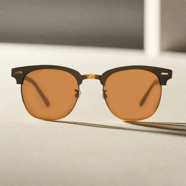 Sunglasses with brown lenses and black frames on a light surface.