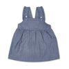 Girl wearing organic chambray cotton overall dress in dark indigo wash by Apple Park