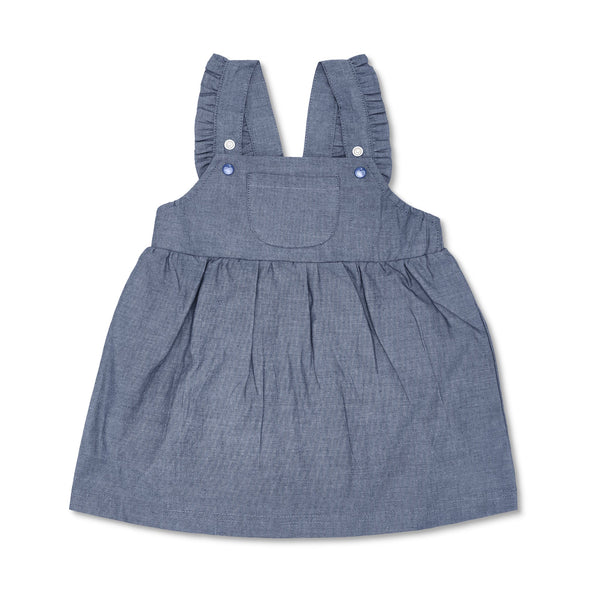 Girl wearing organic chambray cotton overall dress in dark indigo wash by Apple Park