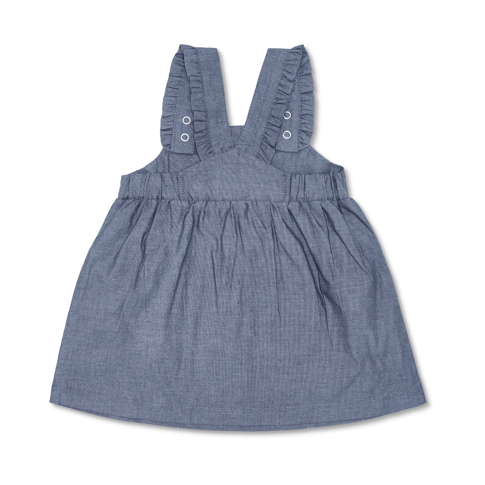 Close-up detail of organic chambray overall dress showing elastic waist and ruffle strap detail
