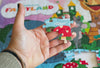 Close-up detail of the Children's Fairyland puzzle pieces showing ribbon-cut interlocking design and vibrant artwork by Greg Berger