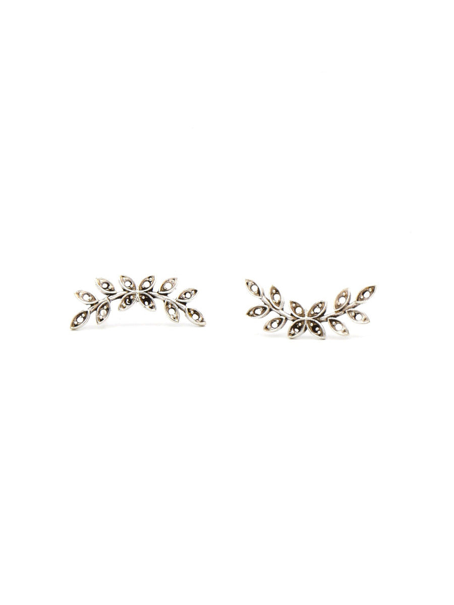 Pair of Fair Anita nickel-free silver leaf stud earrings laid flat, product detail view