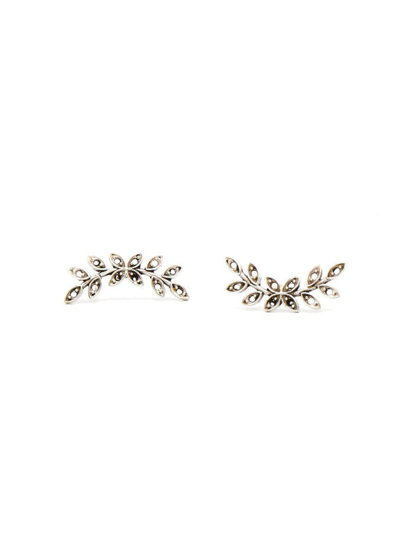 Pair of Fair Anita nickel-free silver leaf stud earrings laid flat, product detail view