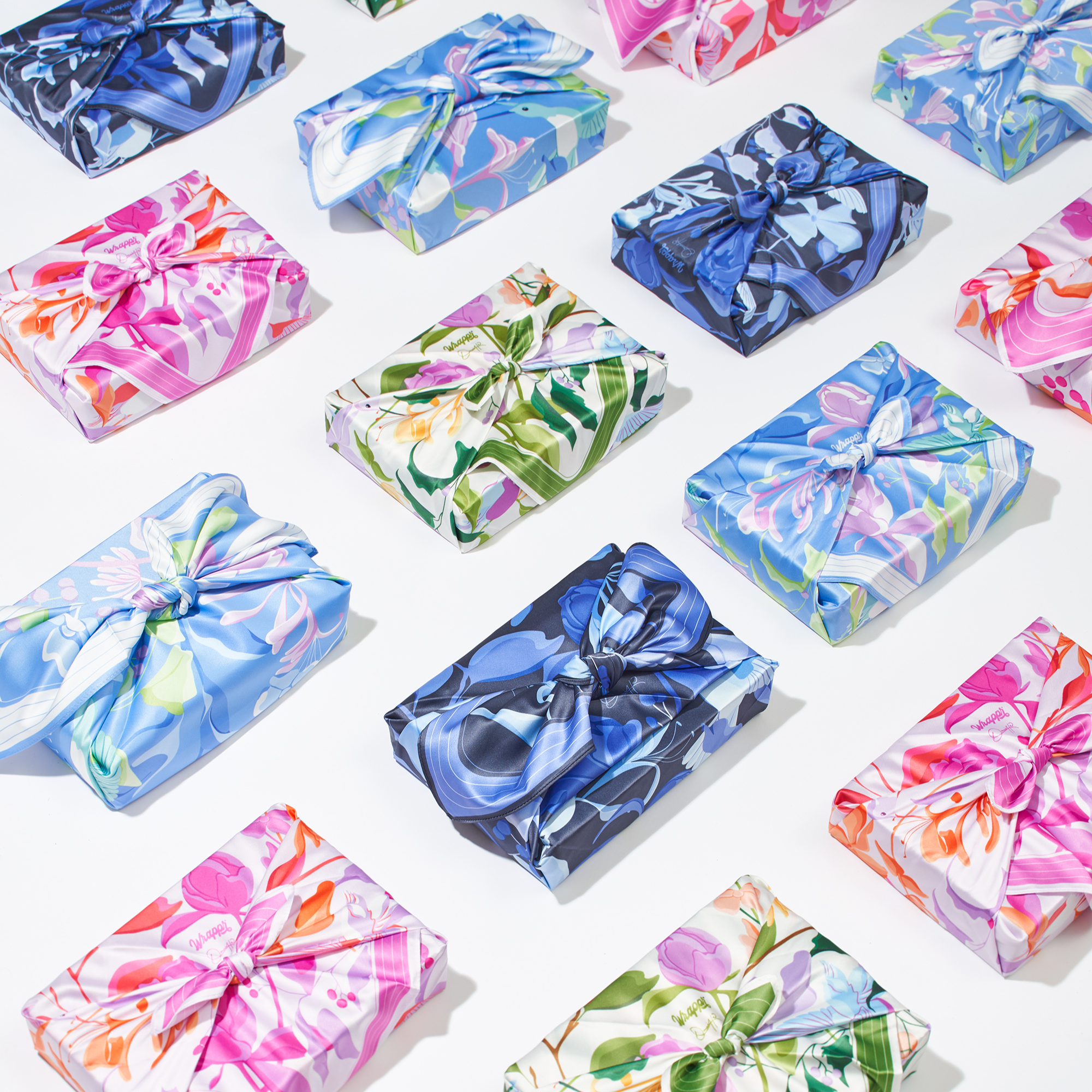 Colorful gift boxes with floral patterns and ribbons on a white background