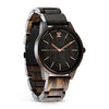 Wooden watch with black face and rose gold accents on a white background