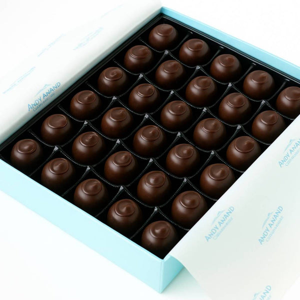 Box of chocolates with a white and blue design on a white background