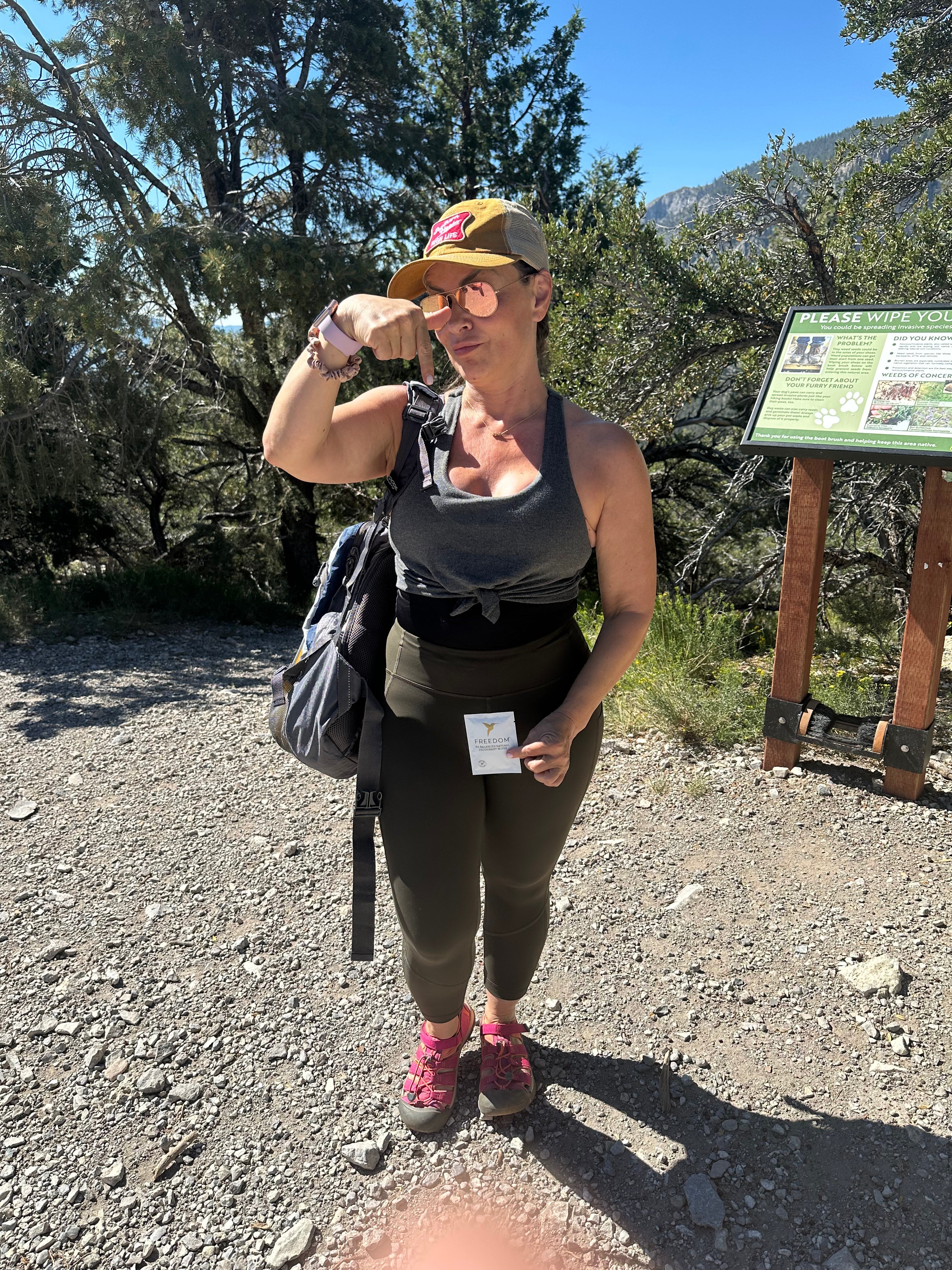 Woman hiking on a trail with a scenic background