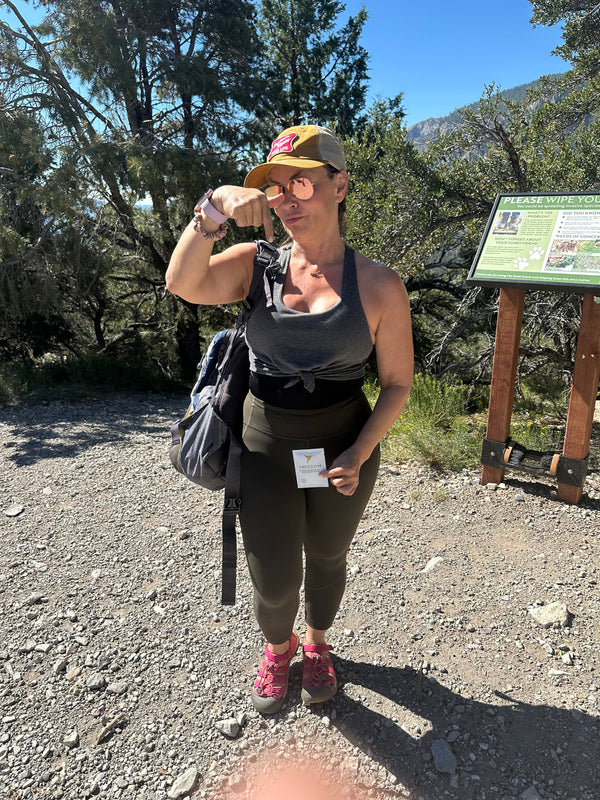 Woman hiking on a trail with a scenic background