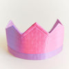 Pink and purple crown on a light gray background