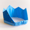 Blue crown with star patterns on a light background