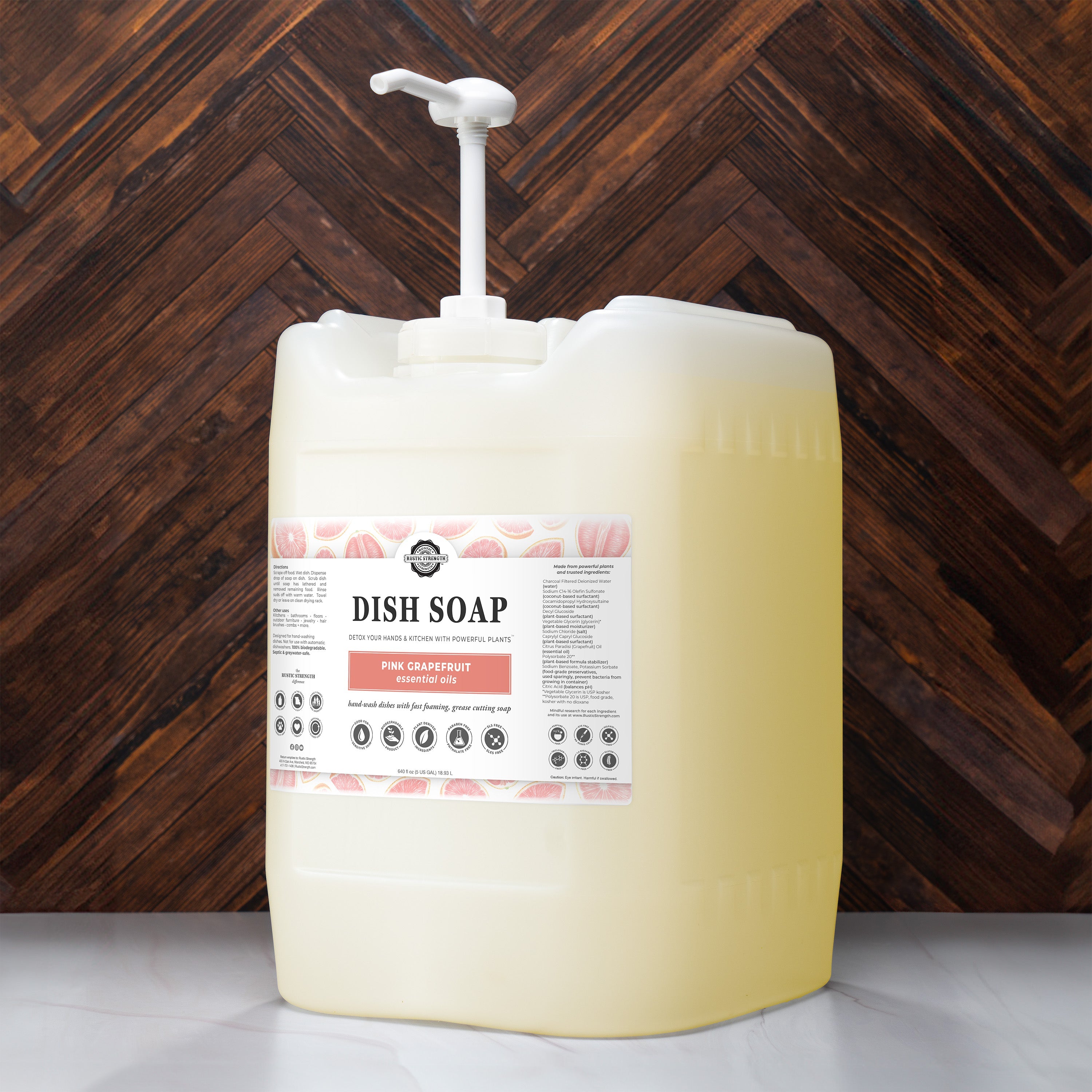 Large container of dish soap with a pump against a wooden background