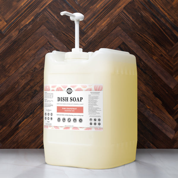 Large container of dish soap with a pump against a wooden background