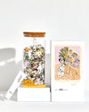Jigsaw puzzle jar, box, and Dalmatian-themed card on a white background