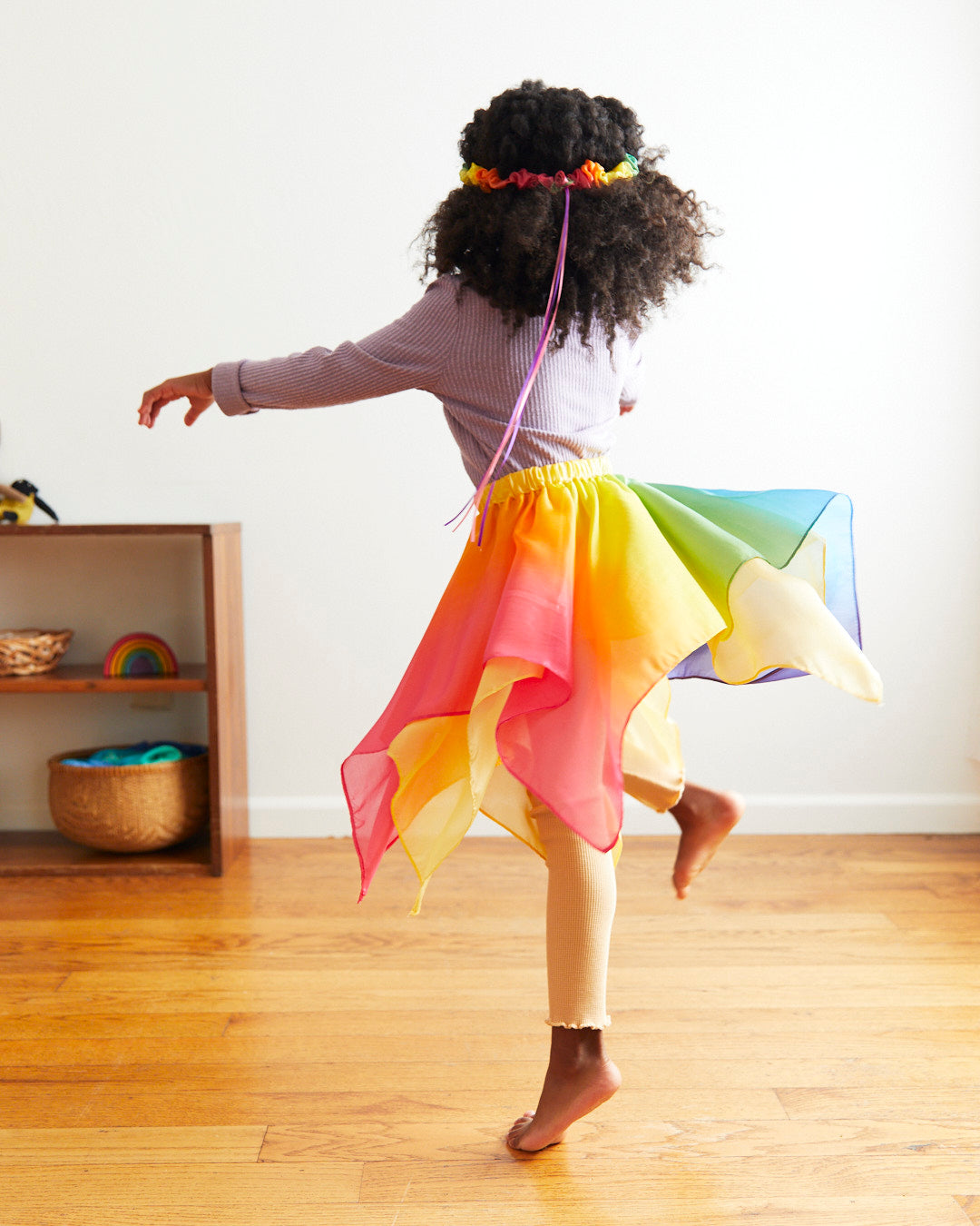 Transform your child into a magical fairy with our Rainbow Silk Fairy Skirt. This versatile and comfortable skirt is perfect for dress-up, Halloween, and endless imaginative adventures.