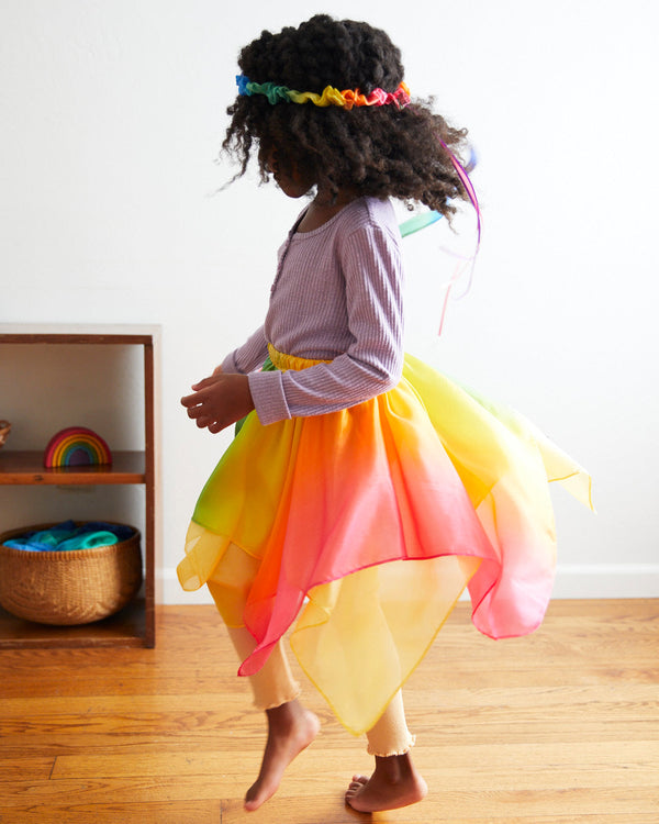 Transform your child into a magical fairy with our Rainbow Silk Fairy Skirt. This versatile and comfortable skirt is perfect for dress-up, Halloween, and endless imaginative adventures.