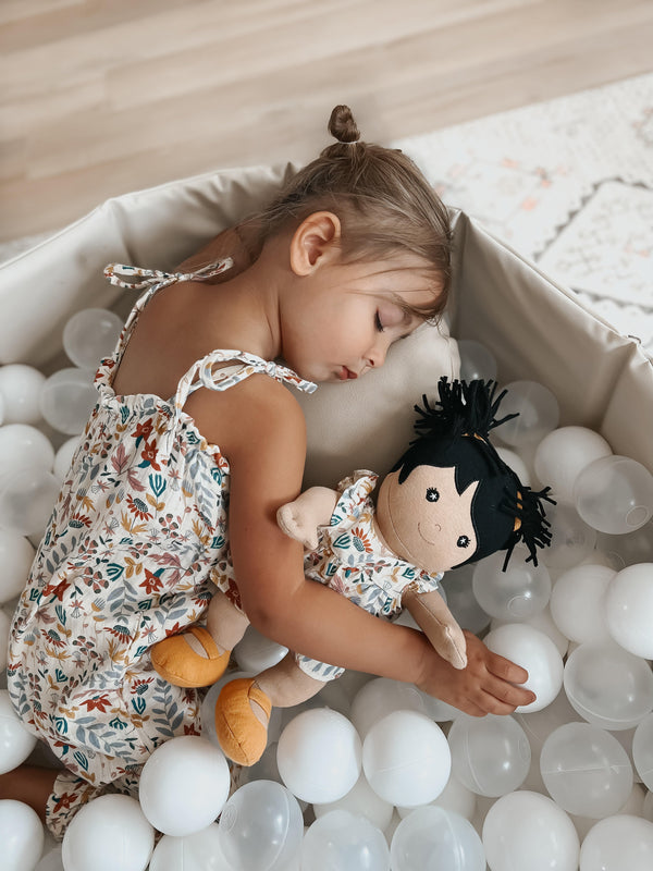 Baby in Earthtone Floral Muslin Tie Shoulder Jumpsuit alongside Gwen doll in matching Earthtone Floral muslin doll dress
