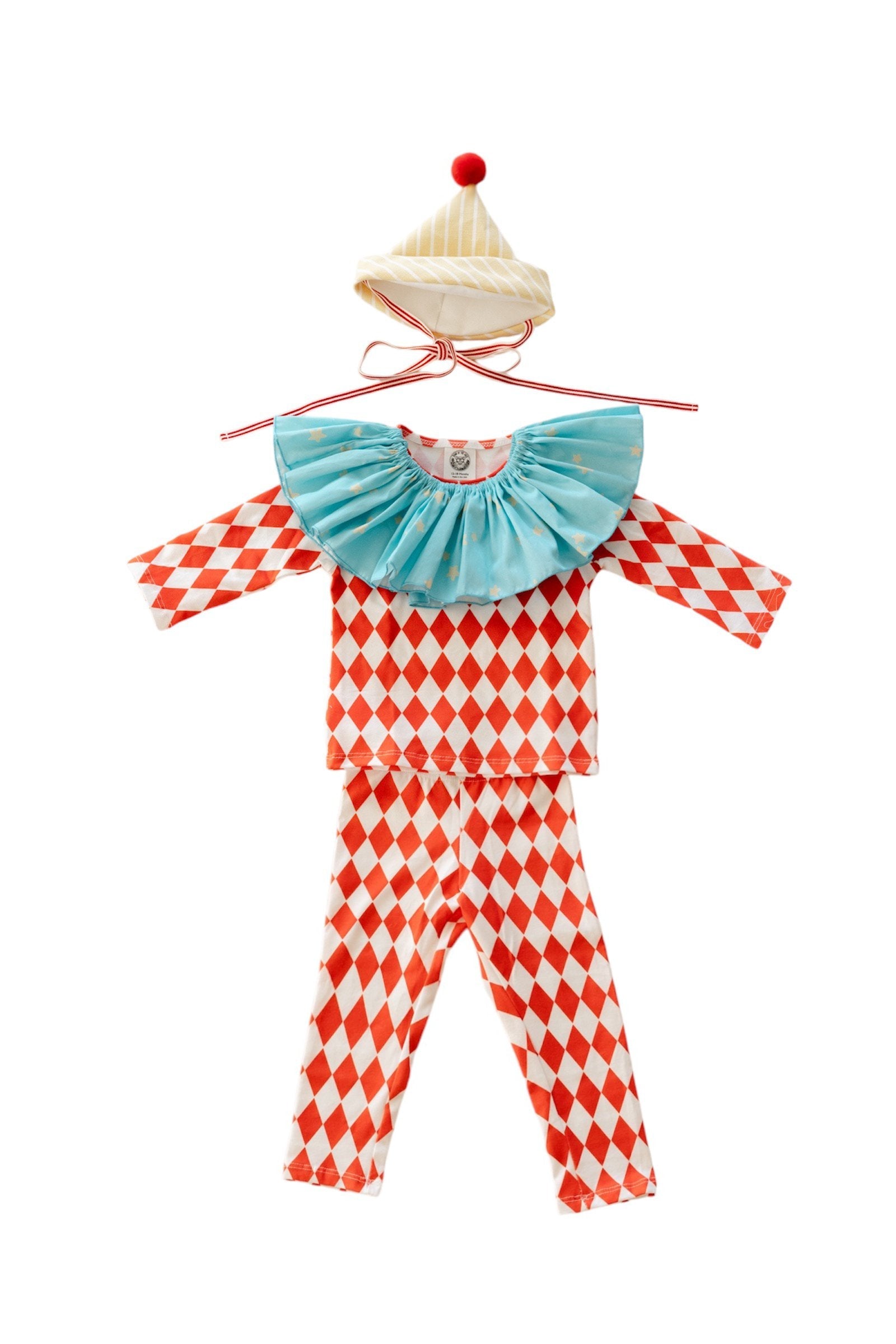 Children's clown outfit with red and white checkered pattern, blue ruffled top, and red hat on a white background.