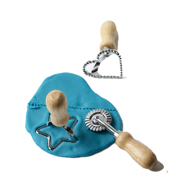 Three dough cutters with wooden handles on a blue cushion against a white background
