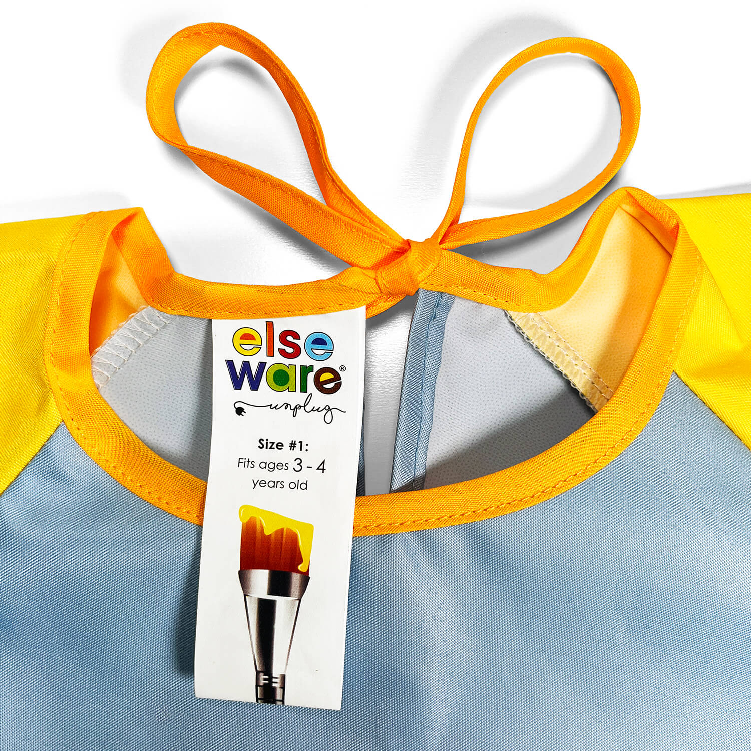 Close-up of kids art smock front pocket detail, 100% polyester water-repellent fabric
