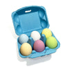 Blue egg carton with pastel-colored eggs on a white background