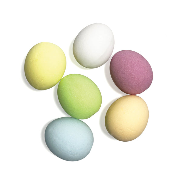 Set of six pastel-colored makeup sponges on a white background