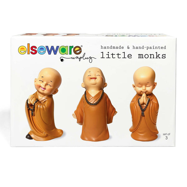 Set of three handmade hand-painted polyresin monk figurines on a white background