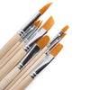 Set of paintbrushes with wooden handles and orange bristles on a white background