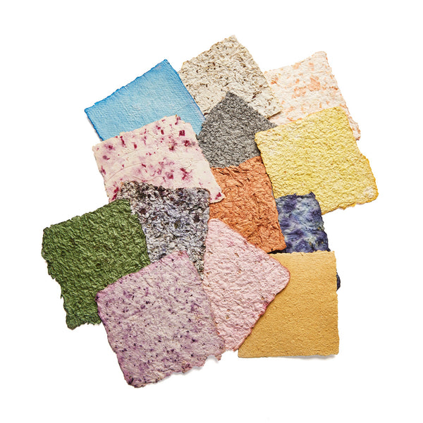Collection of colorful textured square cloths on a white background