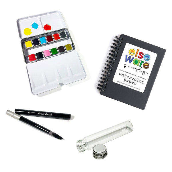 Open watercolor travel kit showing 12 vibrant color pans in a compact metal case