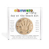 elseware day at the beach kit packaging with sand art and hand print on a white background