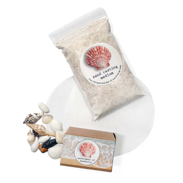 Bag of sand casting medium with a small box and seashells on a white background