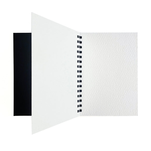 Small watercolor paper pad by elseware unplug displayed open, showing thick cotton rag pages