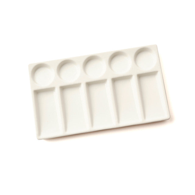 Rectangular ceramic palette with multiple compartments on a white background