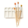 Set of paintbrushes on a white paint palette