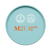 M21 Luxury Tea container lid with branding and certification logos on a light blue background