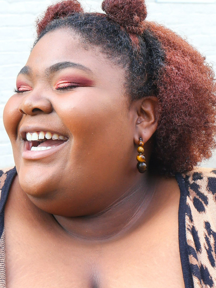 Tiger eye beaded hoop earrings styled on model, handmade by women artisans in Mexico