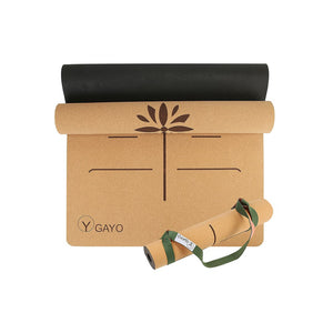 Gayo eco-friendly cork yoga mat rolled up with carrying strap on a white background